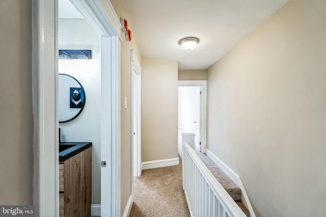 hallway featuring light carpet