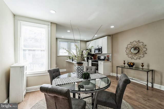 dining room with hardwood / wood-style flooring