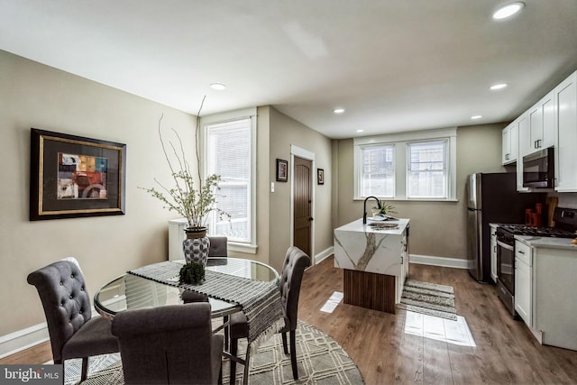 dining room featuring sink and hardwood / wood-style flooring