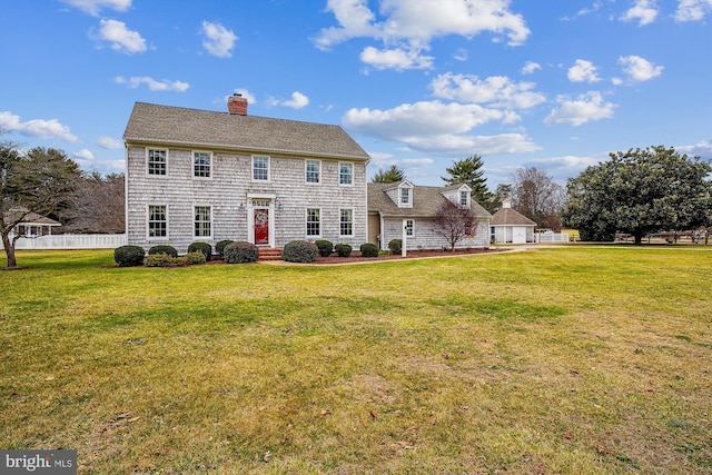 back of house with a lawn