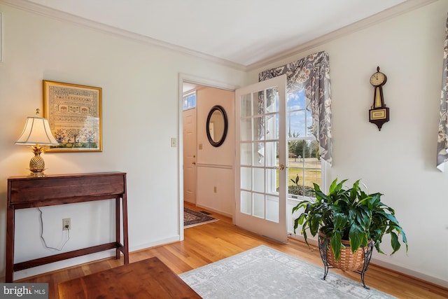 entryway with ornamental molding and wood-type flooring