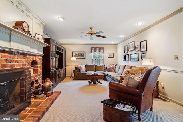 carpeted living room with ornamental molding, a brick fireplace, and ceiling fan