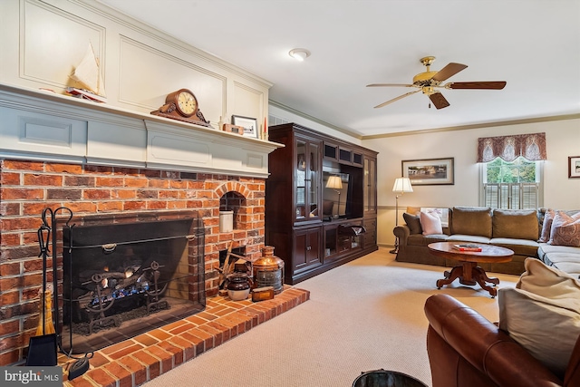 carpeted living room featuring ceiling fan, ornamental molding, and a fireplace