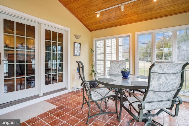 sunroom / solarium featuring wood ceiling, lofted ceiling, and rail lighting