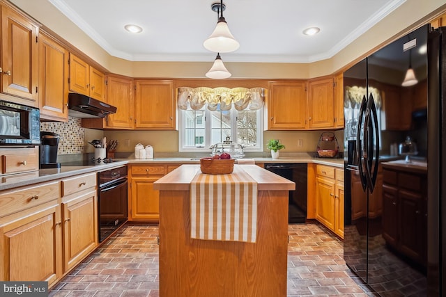 kitchen with crown molding, wooden counters, a center island, and black appliances