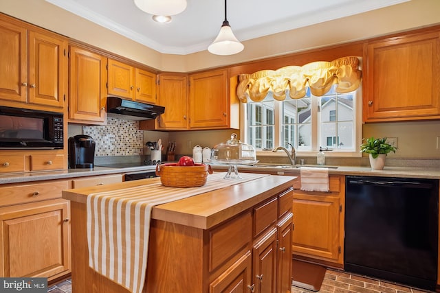 kitchen featuring pendant lighting, butcher block countertops, ornamental molding, a center island, and black appliances