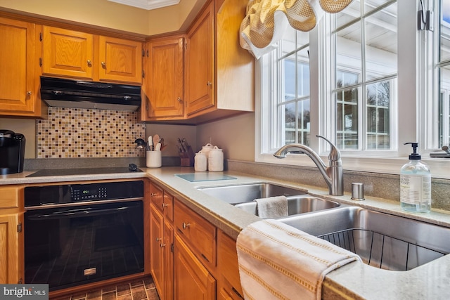 kitchen with sink, decorative backsplash, and black appliances