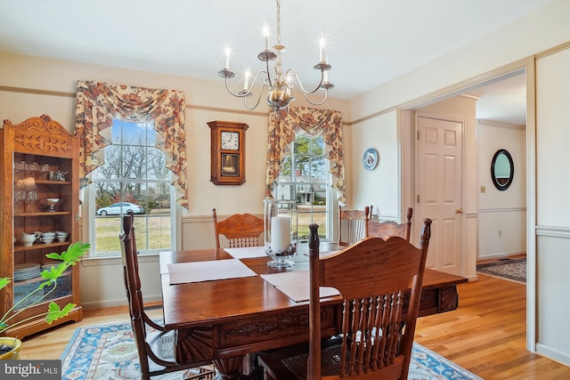 dining room with an inviting chandelier and light wood-type flooring