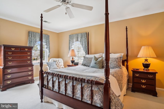 carpeted bedroom featuring crown molding and ceiling fan