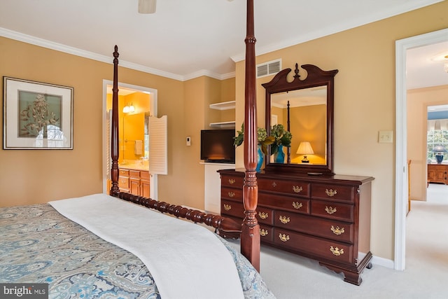 bedroom featuring crown molding, ensuite bath, and light carpet