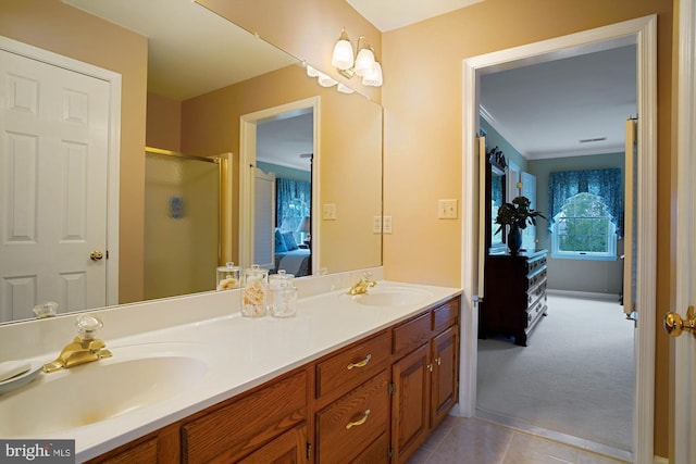 bathroom featuring vanity, crown molding, tile patterned floors, and walk in shower