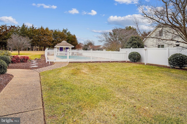 view of yard featuring a fenced in pool and a gazebo