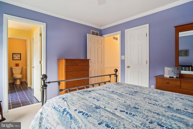 carpeted bedroom with crown molding and ensuite bath