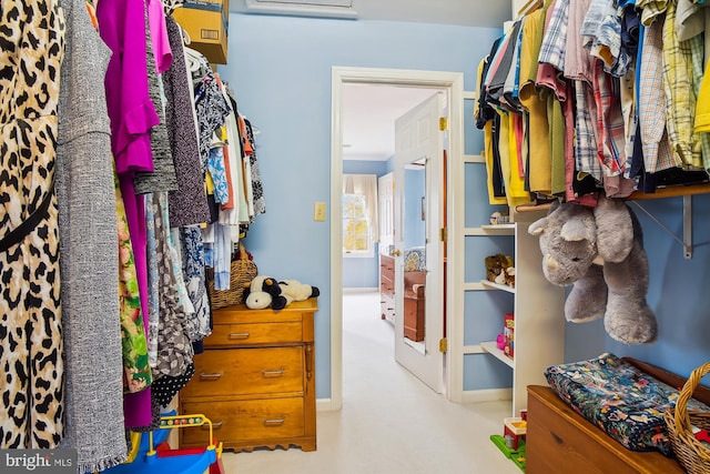 walk in closet featuring light colored carpet