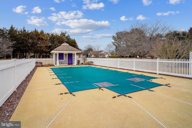 view of swimming pool with an outbuilding