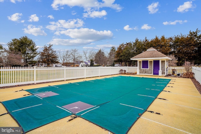 view of pool with an outdoor structure and a patio area