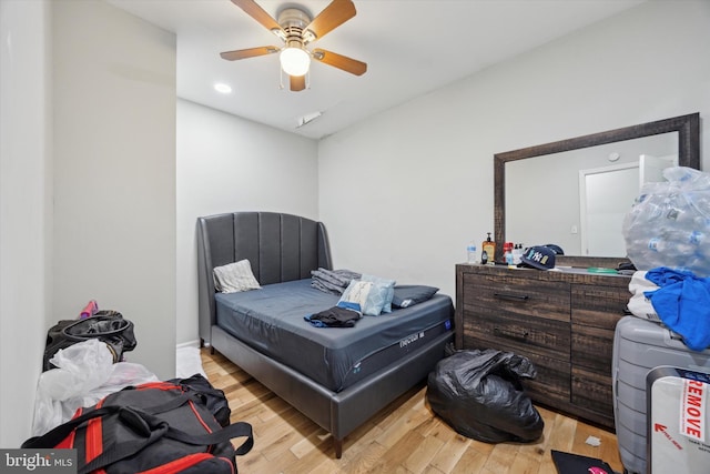 bedroom with light hardwood / wood-style floors and ceiling fan