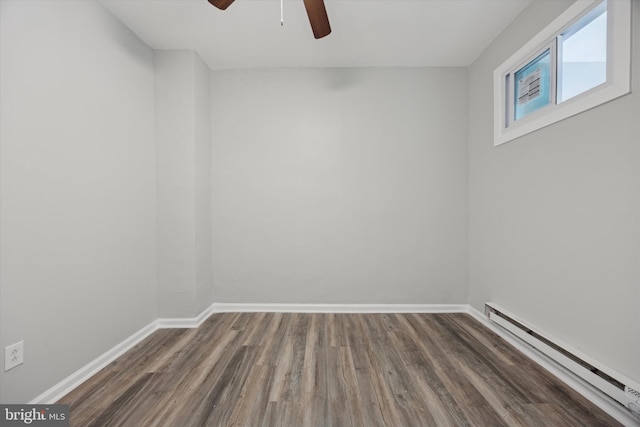 spare room with ceiling fan, a baseboard radiator, and dark hardwood / wood-style floors