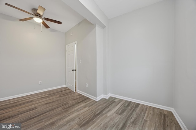 empty room featuring ceiling fan and dark hardwood / wood-style flooring