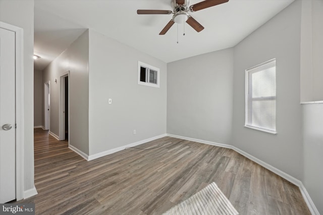 spare room featuring hardwood / wood-style floors and ceiling fan