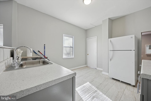 kitchen featuring sink and white fridge