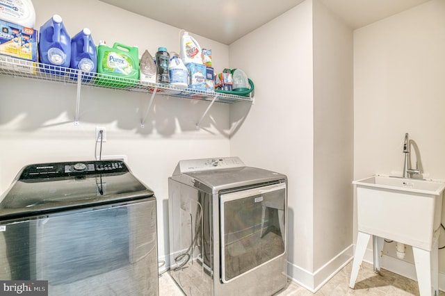 clothes washing area featuring washer and clothes dryer