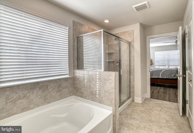 bathroom with separate shower and tub