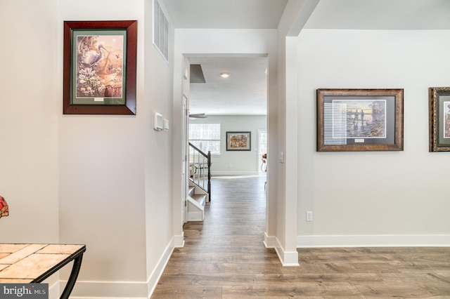 hallway with hardwood / wood-style floors