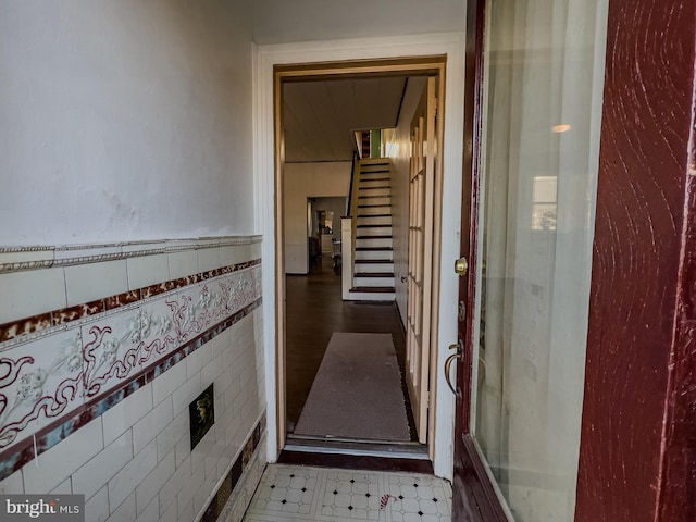 hallway featuring tile walls