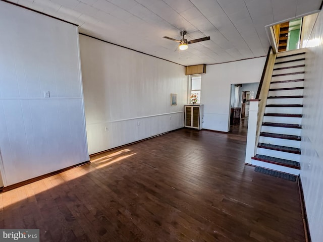 unfurnished living room with dark wood-type flooring and ceiling fan