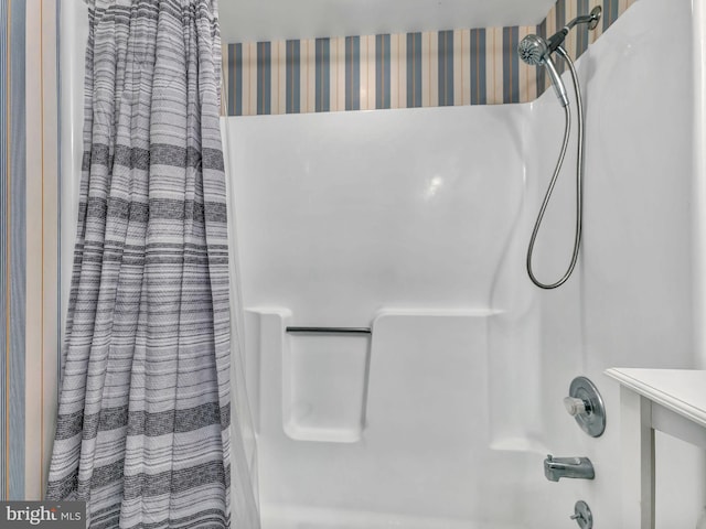 bathroom with shower / bathtub combination with curtain