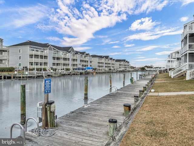 dock area featuring a water view and a lawn