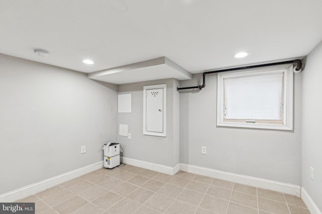 basement featuring light tile patterned flooring