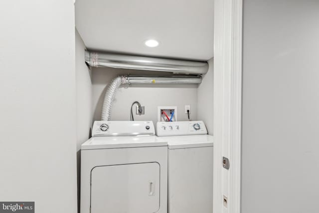 clothes washing area featuring separate washer and dryer