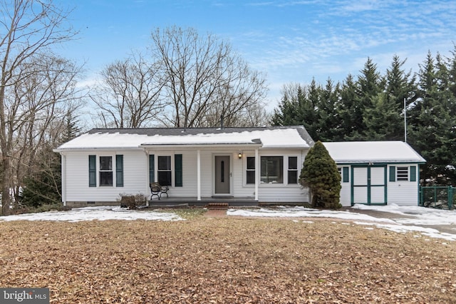 ranch-style home with covered porch and a front yard