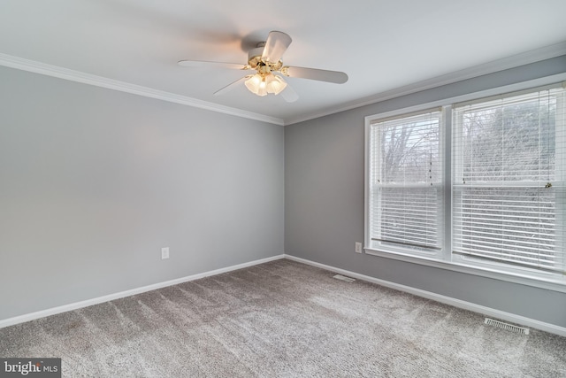 empty room with crown molding, carpet floors, and ceiling fan