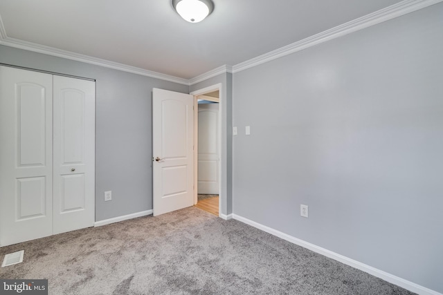 unfurnished bedroom with light carpet, a closet, and ornamental molding