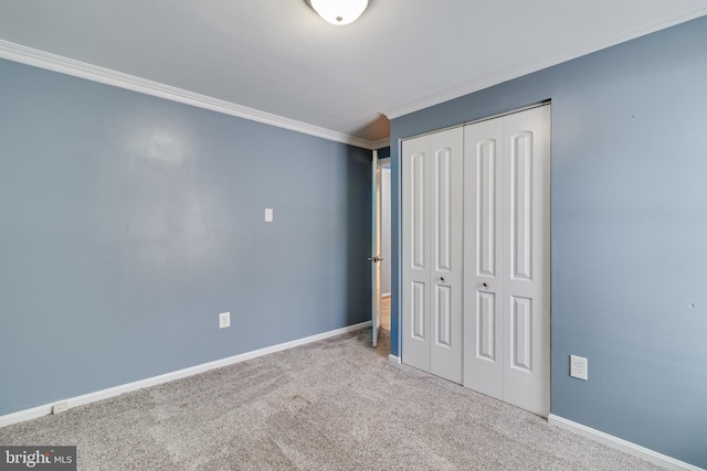 unfurnished bedroom featuring carpet floors, a closet, and ornamental molding