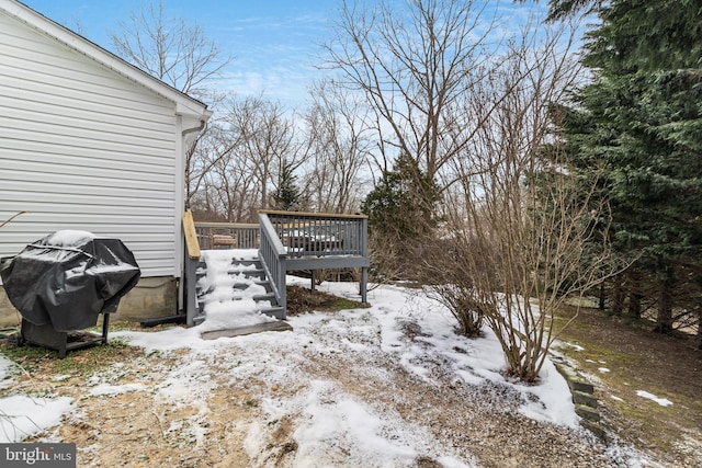 snowy yard featuring a deck