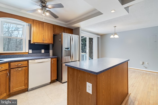 kitchen featuring pendant lighting, stainless steel fridge, white dishwasher, a center island, and ornamental molding