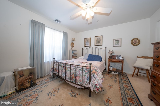 bedroom with light colored carpet and ceiling fan