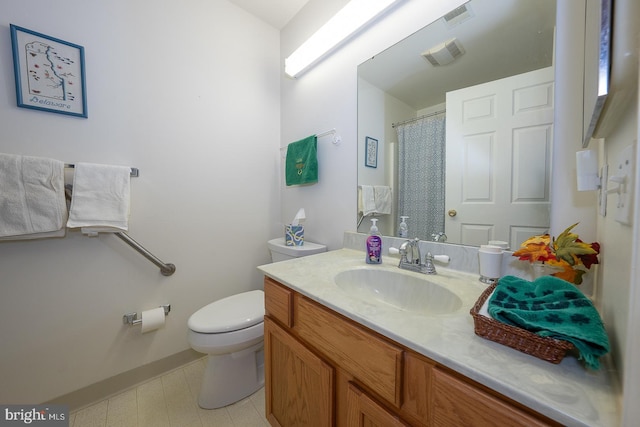 bathroom with toilet and vanity