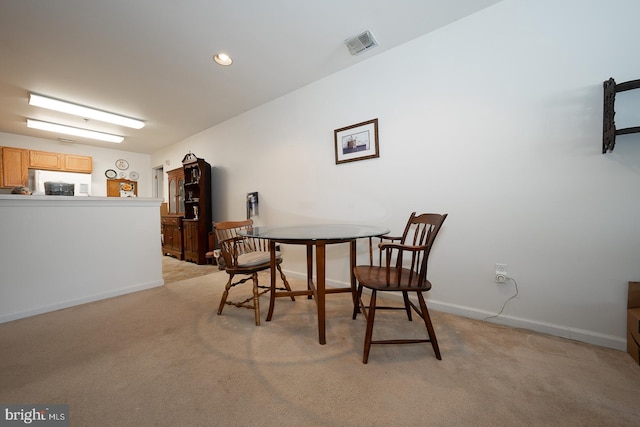 dining room with light colored carpet