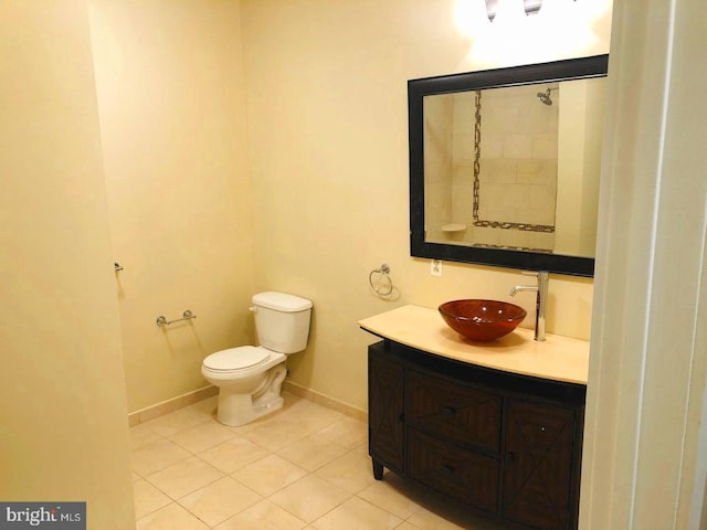 bathroom with tile patterned flooring, vanity, and toilet