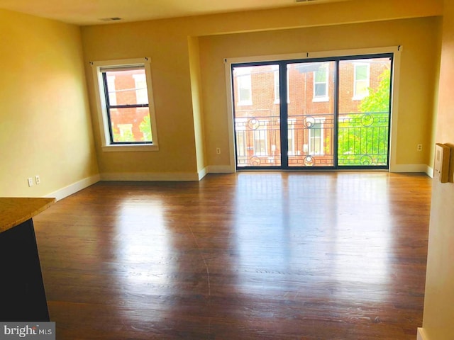 unfurnished room with wood-type flooring