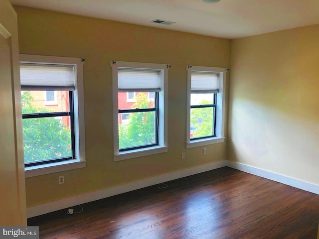 empty room featuring dark wood-type flooring