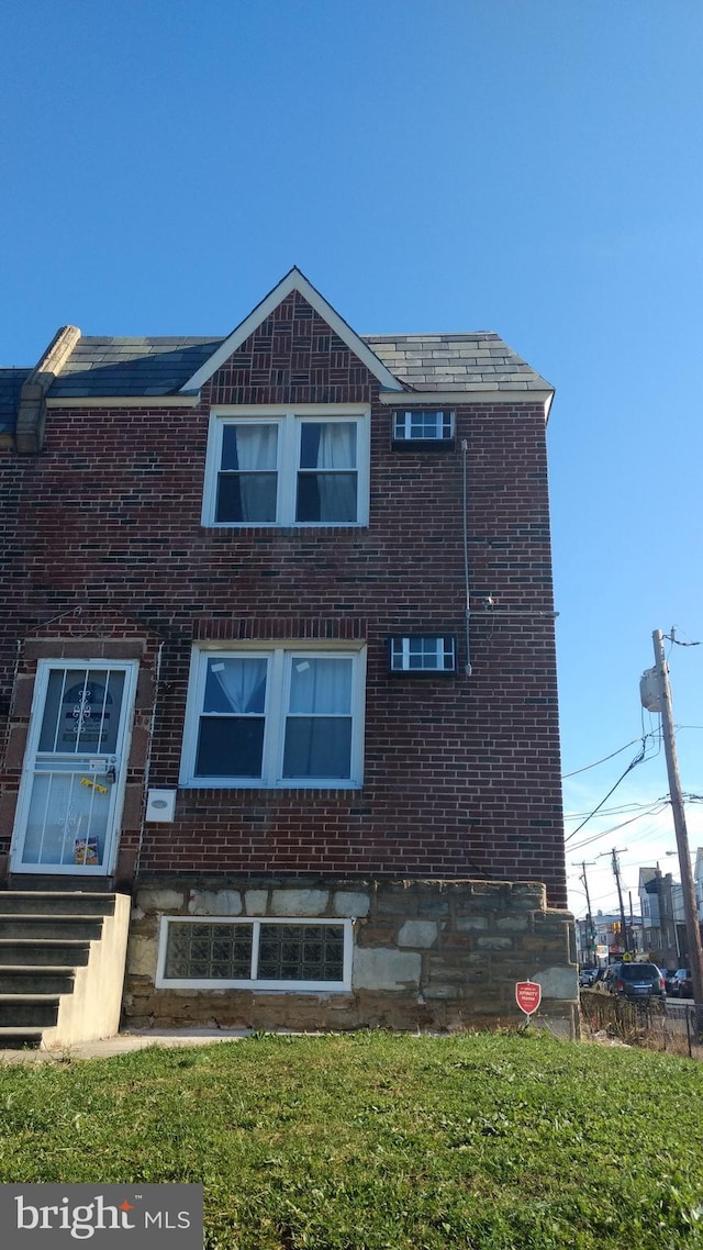 rear view of property featuring a yard