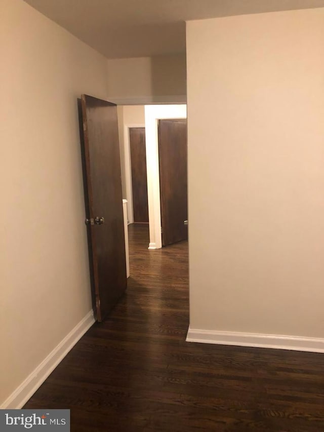 hallway with dark wood-type flooring