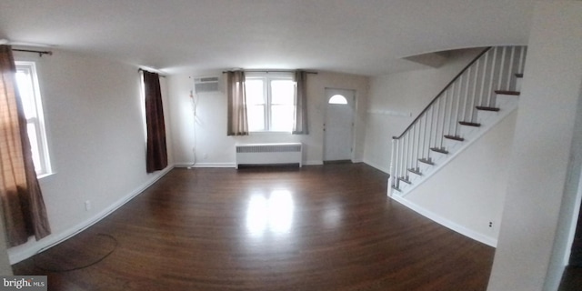 entryway with radiator heating unit and dark hardwood / wood-style flooring