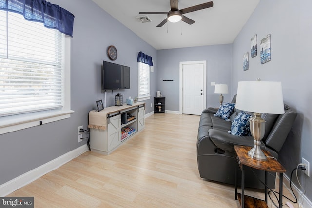 living room with light hardwood / wood-style floors and ceiling fan